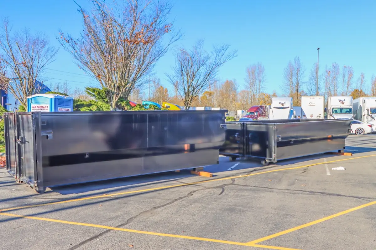 Professional dumpster rental service with roll-off container on residential driveway in Mays Chapel